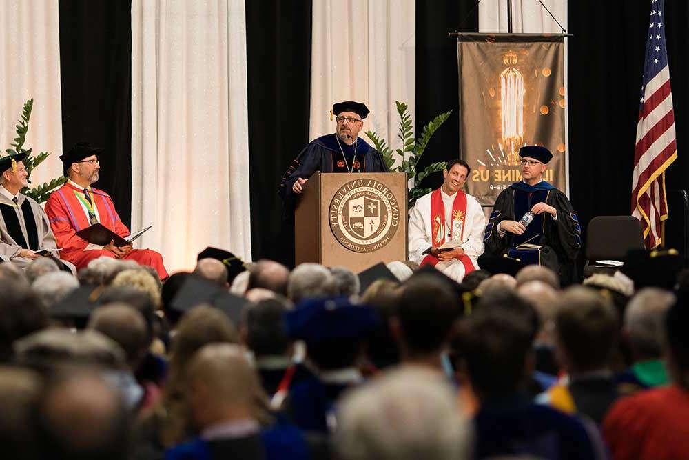 President Thomas speaking at the podium