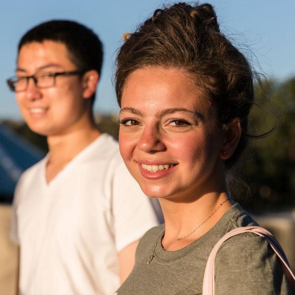 Male and female students in front of Grimm Hall