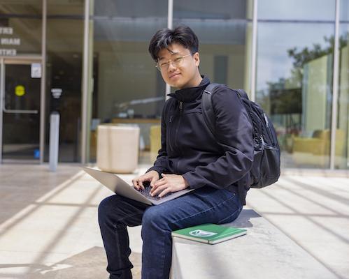 Student sitting with laptop