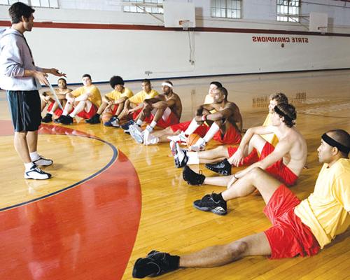 Basketball coach talking to his players