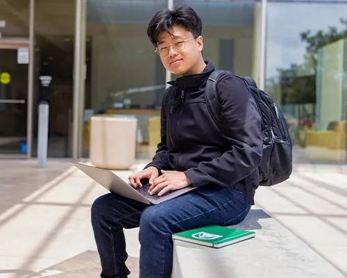 Concordia University Student working on his laptop